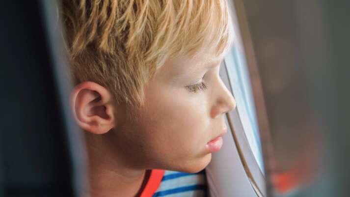 Ein Kind schaut aus dem Flugzeugfenster